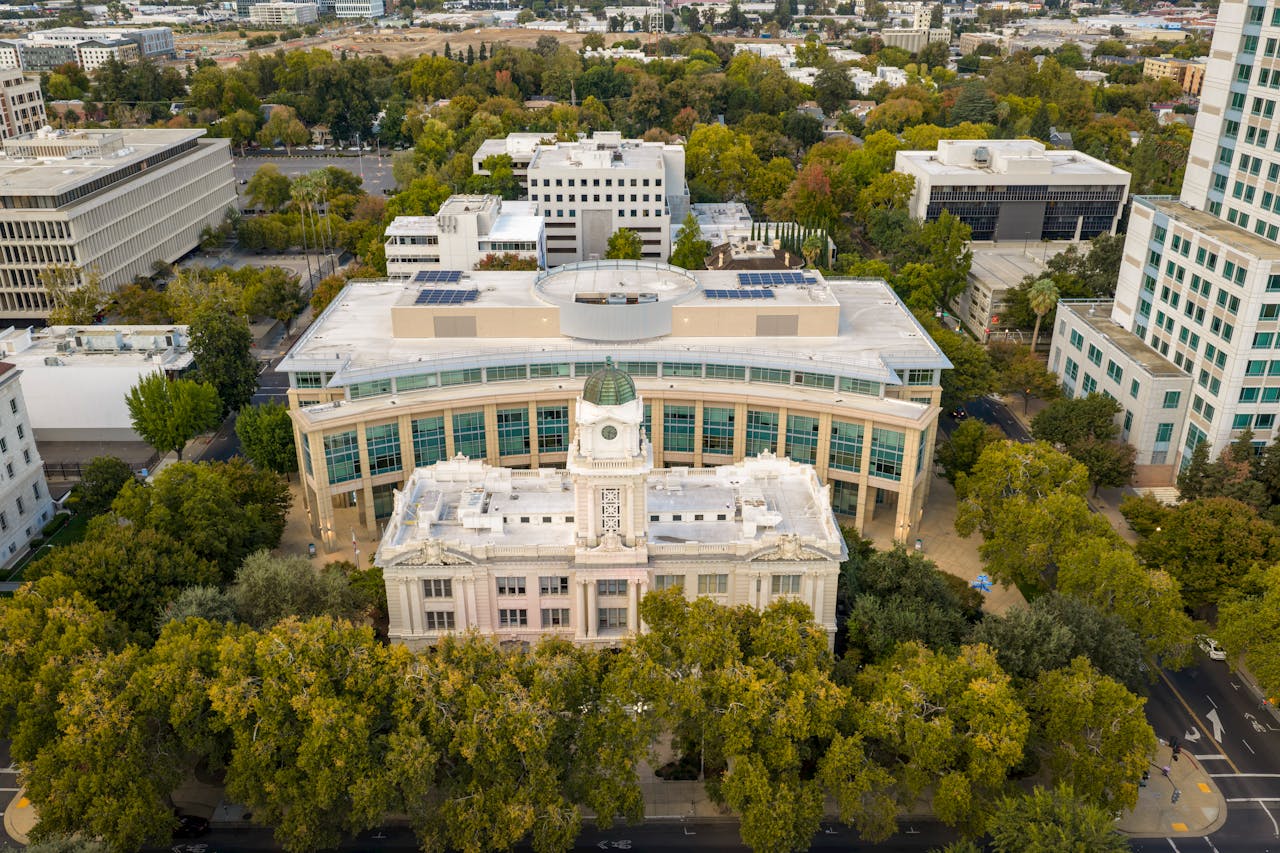 Stunning aerial view of a landmark building surrounded by lush trees in Sacramento, California.